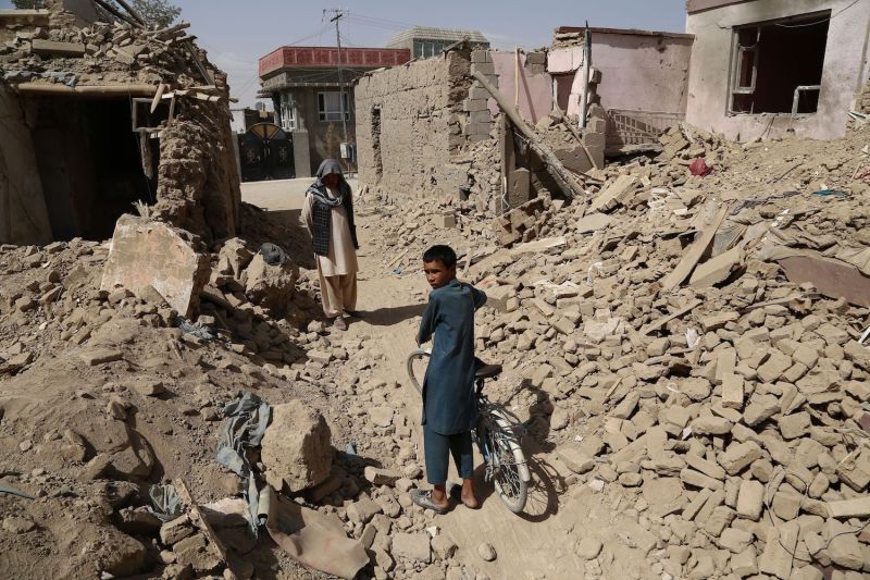 Afghan residents walk near destroyed houses after a Taliban attack in Ghazni on Aug. 16. (Zakeria Hashimi/AFP/Getty Images)