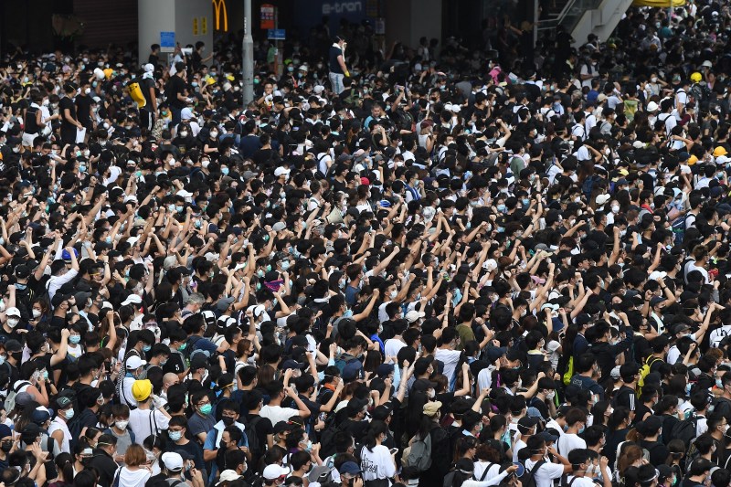 Protesters shout out after police fired tear gas during a rally against a controversial extradition law proposal in Hong Kong on June 12, 2019.