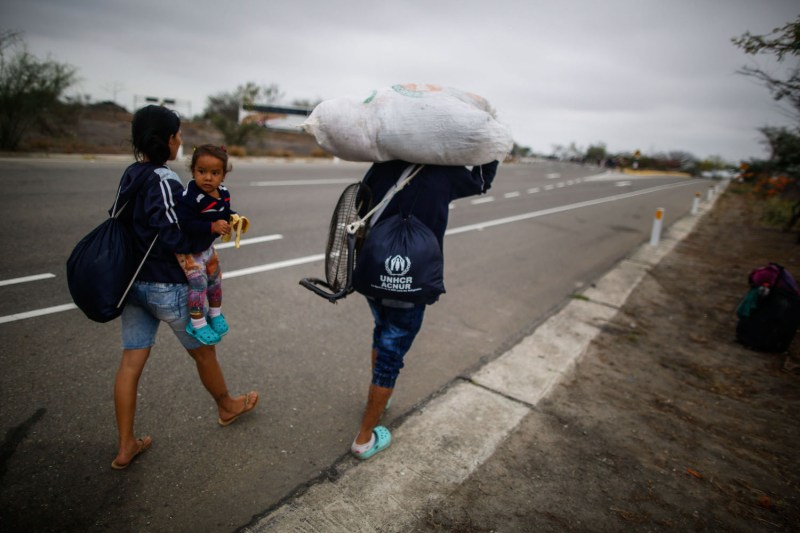 Venezuelan migrants walk along the border of Peru and Ecuador.