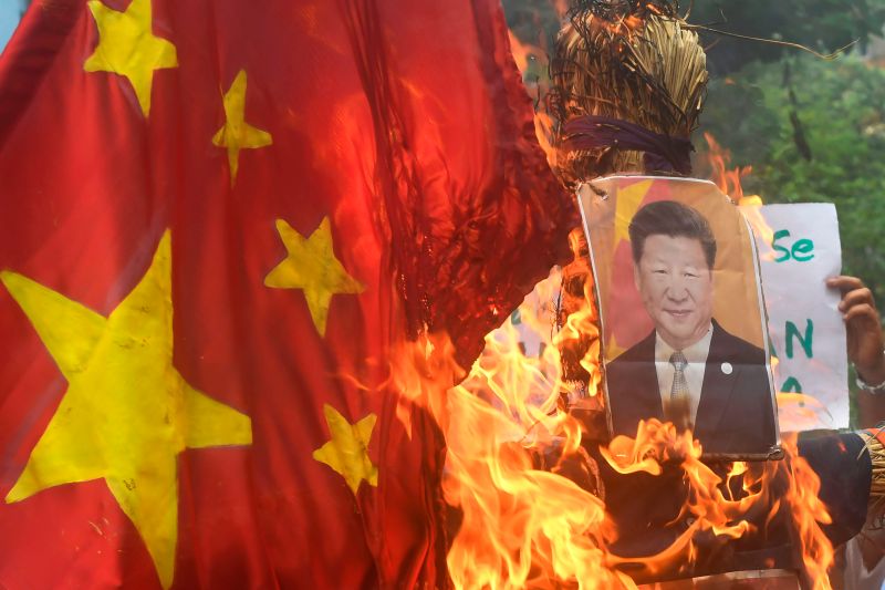 Indian protesters burn an effigy of Chinese President Xi Jinping and a Chinese flag during an anti-China demonstration in Kolkata on June 18.