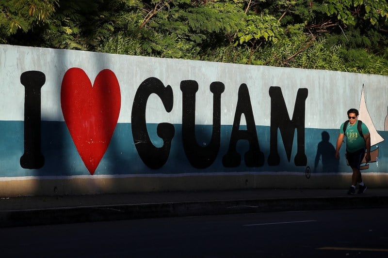 A pedestrian walks by a mural that says “I Love Guam” in Tamuning, Guam, on Aug. 14, 2017.
