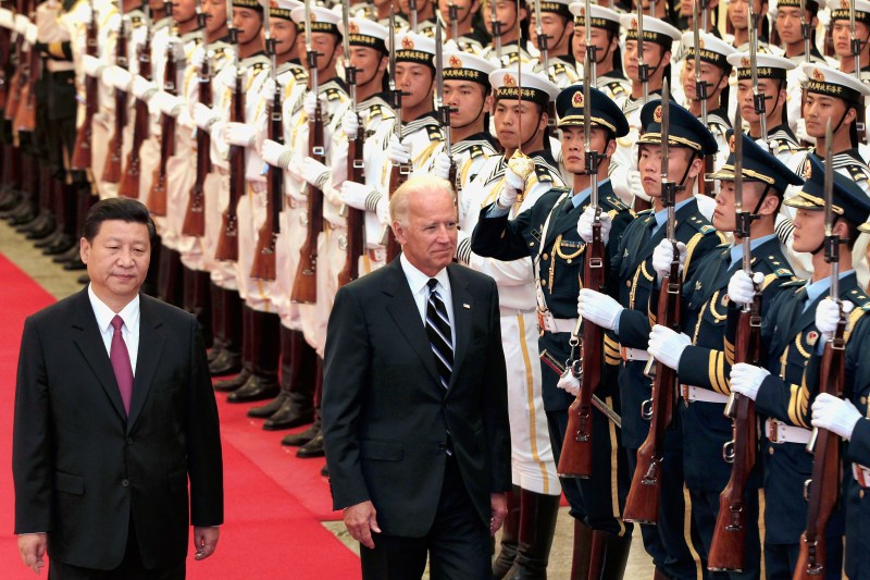 Chinese then-Vice President Xi Jinping and U.S. then-Vice President Joe Biden view an honor guard inside the Great Hall of the People on Aug. 18, 2011 in Beijing.