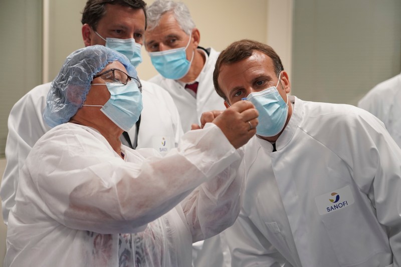 French President Emmanuel Macron visits an industrial development laboratory at French drugmaker's vaccine unit Sanofi Pasteur plant in Marcy-l'Etoile, near Lyon, central France, on June 16, 2020.