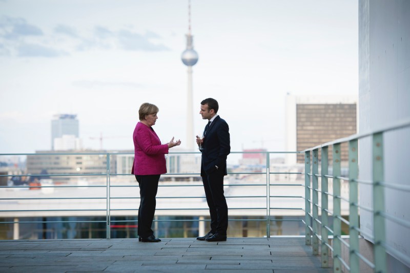 German Chancellor Angela Merkel talks with newly elected French President Emmanuel Macron during his visit to the chancellor’s office in Berlin on May 15, 2017.