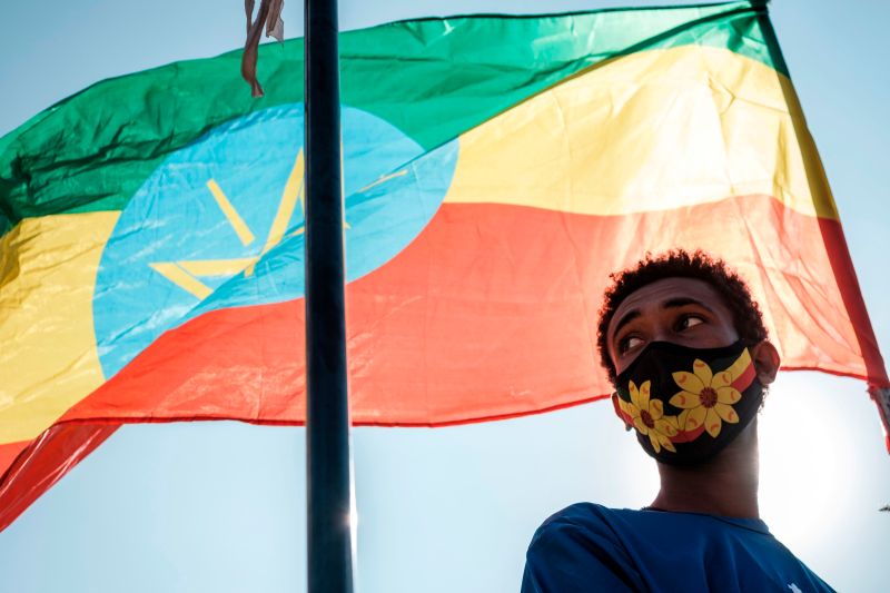 A young person stands below an Ethiopian national flag during a blood donation rally organized by the city administration of Addis Ababa, in Addis Ababa, on Nov. 12, 2020.