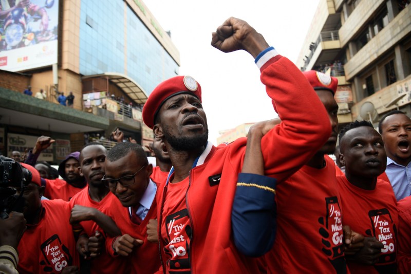 Musician turned politician Bobi Wine (C) is joined by other activists on July 11, 2018 in Kampala, Uganda, during a demonstration to protest a controversial tax on the use of social media.