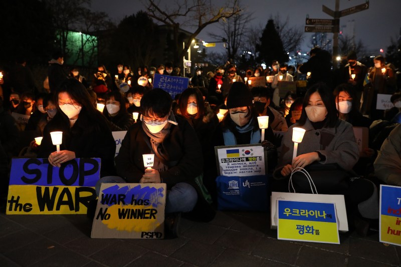 People hold candles during a rally to protest the Russian invasion of Ukraine near the Russian Embassy in Seoul on March 4.