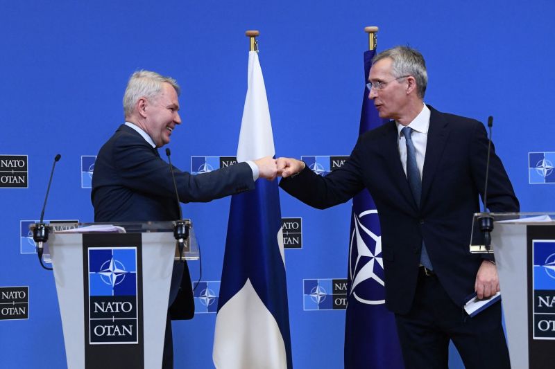 NATO Secretary-General Jens Stoltenberg (R) and Finnish Foreign Minister Pekka Haavisto (L) bump fists after holding a joint press conference after their meeting at NATO headquarters in Brussels on Jan. 24.