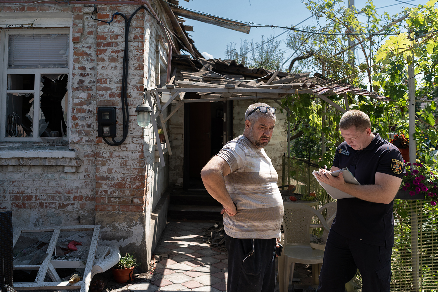 An officer makes a record of the airstrike that hit Eduard’s home.