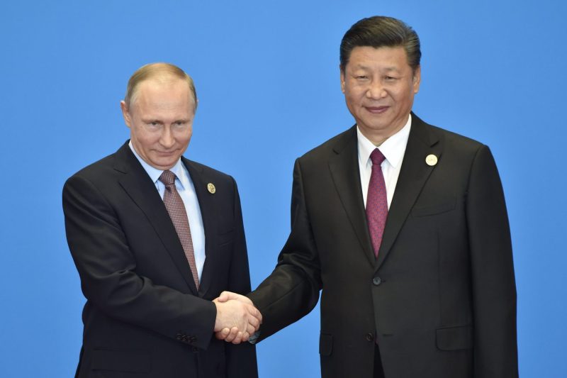 Russian President Vladimir Putin and Chinese President Xi Jinping shake hands at the start of the Belt and Road Forum in Beijing, on May 15, 2017.