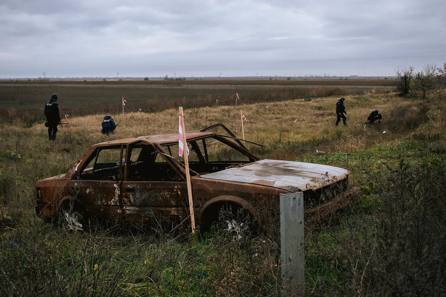 Deminers work with metal detectors in Ukraine.