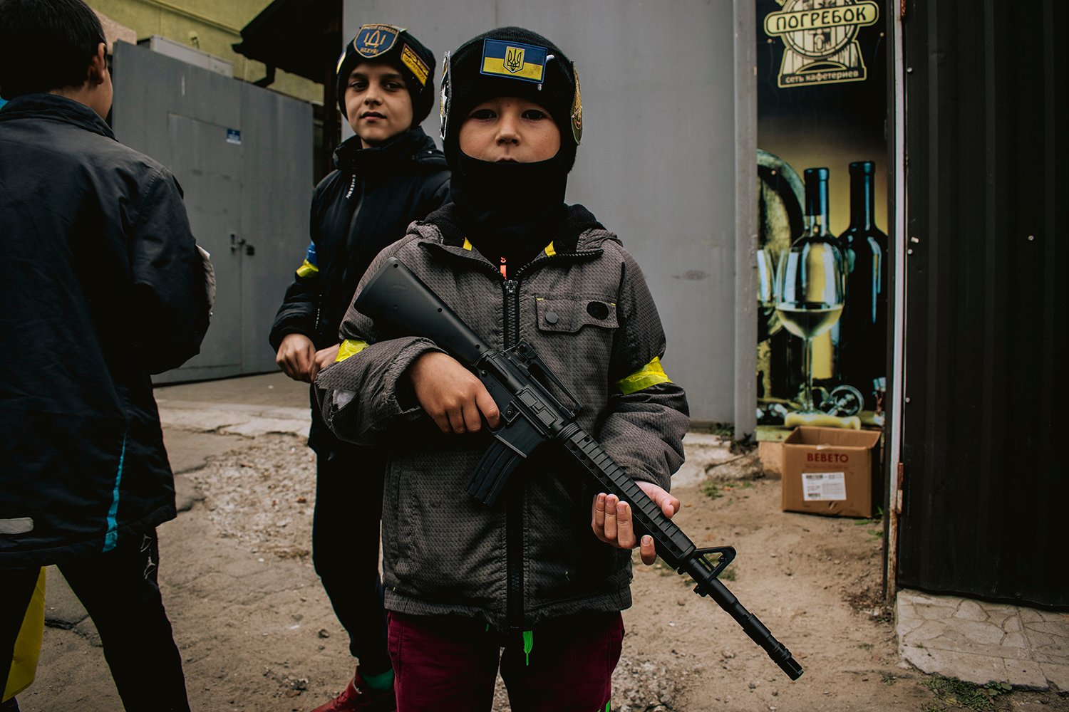 Young boys dress up as Ukrainian soldiers and police officers.