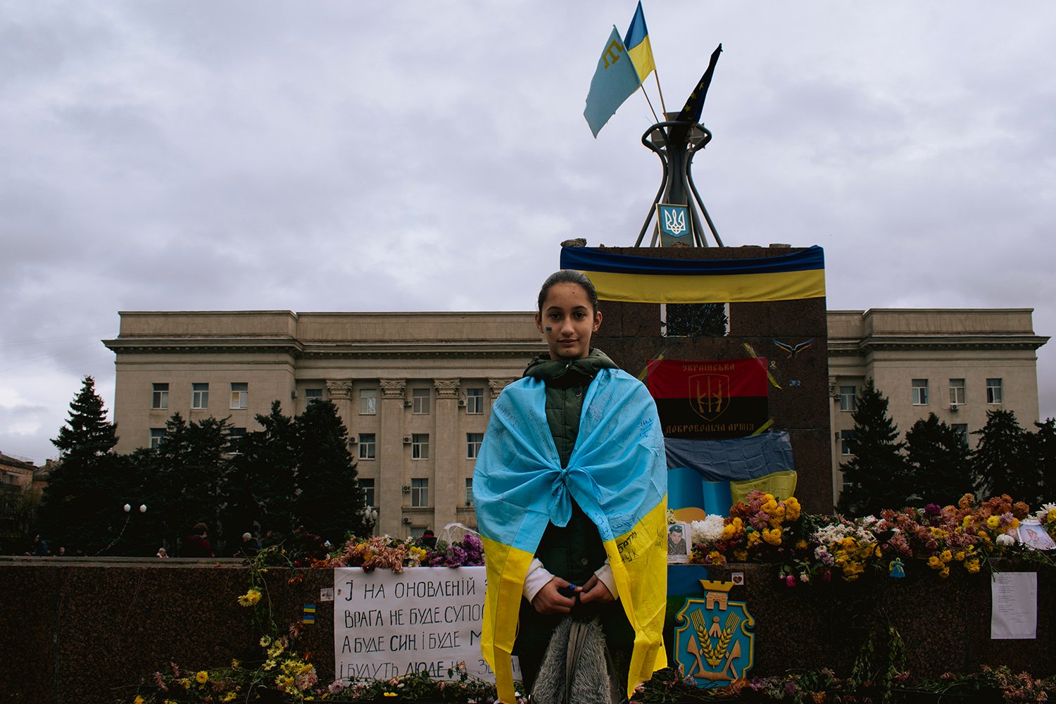 Sara, 12, stands in Kherson’s main square.