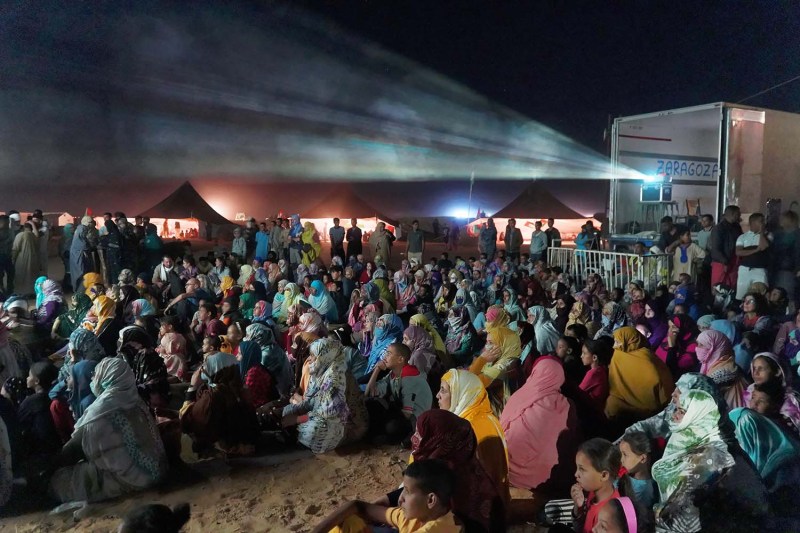 Saharawi festivalgoers gather to watch a nighttime FiSahara screening at Auserd refugee camp in the Western Sahara.