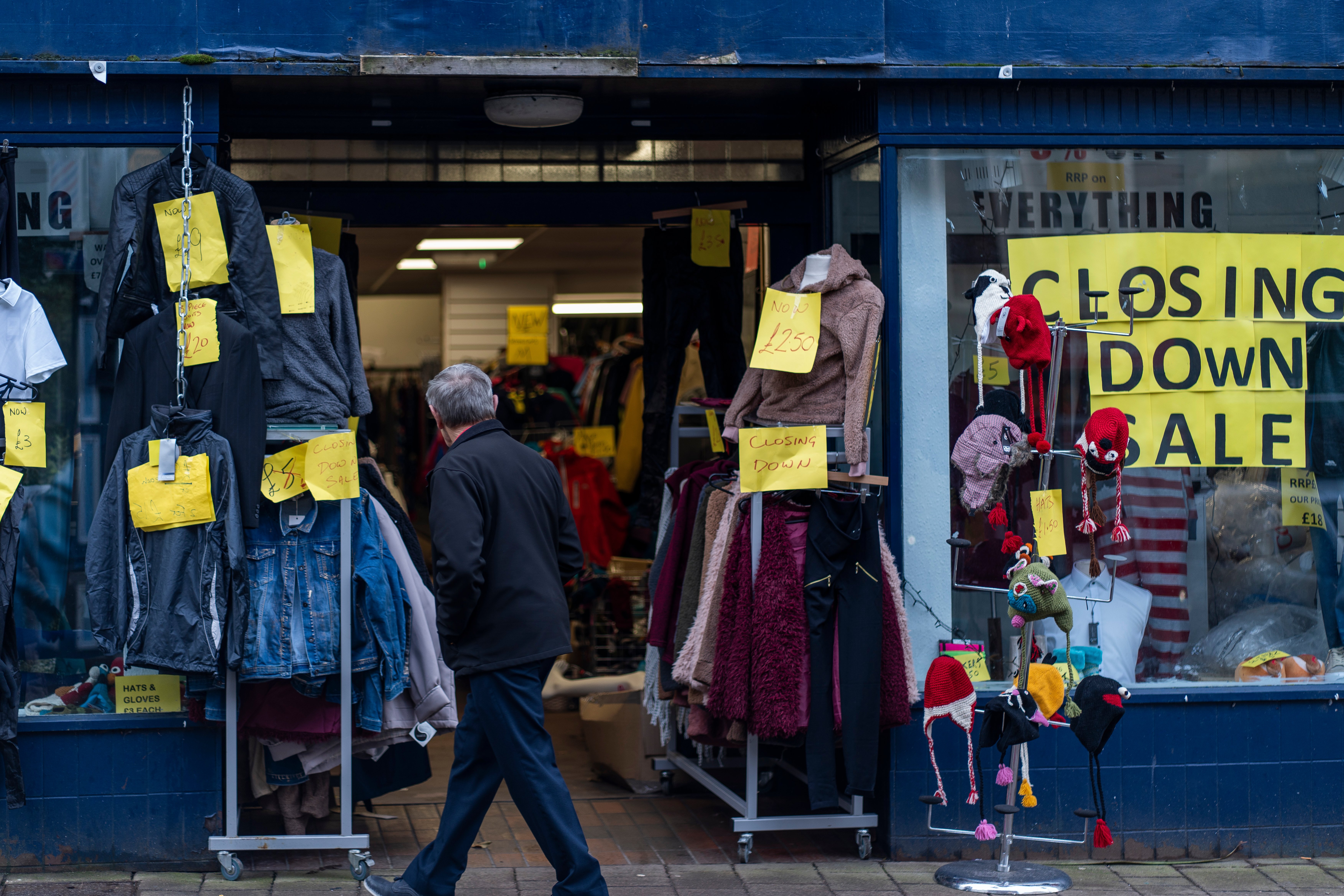 Closing sale signs fill the shop windows at a pedestrian shopping center in Penrith, Britain.