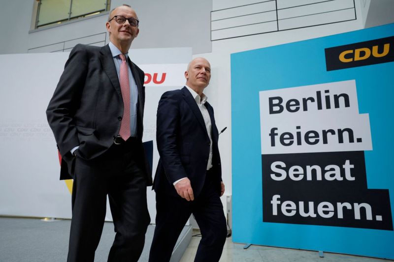 Friedrich Merz, the leader of Germany’s Christian Democratic Union (CDU), and Kai Wegner, the CDU’s top candidate in Berlin, depart after the end of a joint press conference in Berlin on Feb. 13, one day after the city-state’s elections. The campaign placard behind them reads “Celebrate Berlin. Fire the Council.”