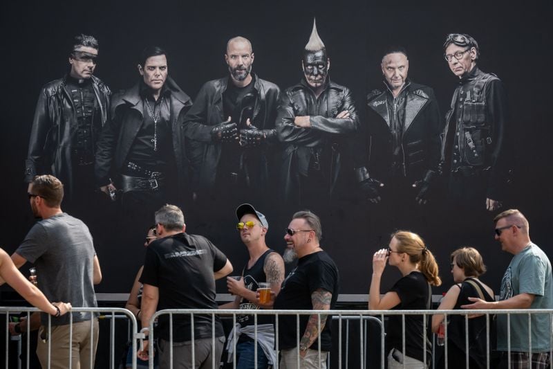 Fans of the German band Rammstein line up under portraits of band members prior to a concert at Wankdorf Stadium in Bern, Switzerland.