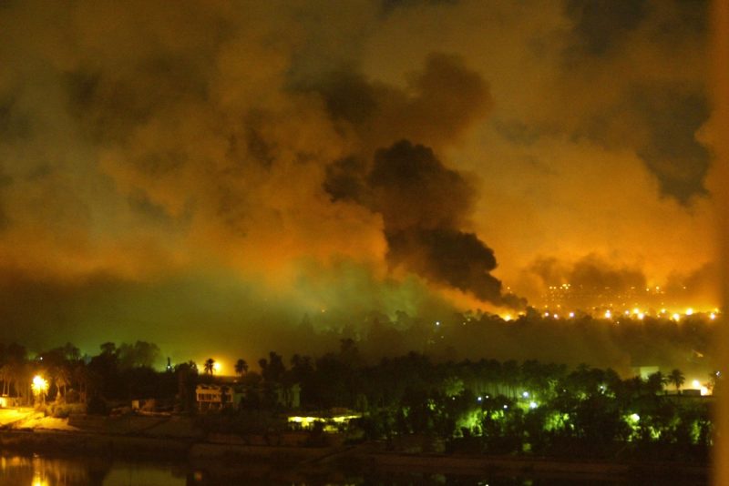 Smoke covers the presidential palace compound in Baghdad during a U.S.-led air raid on March 21, 2003.