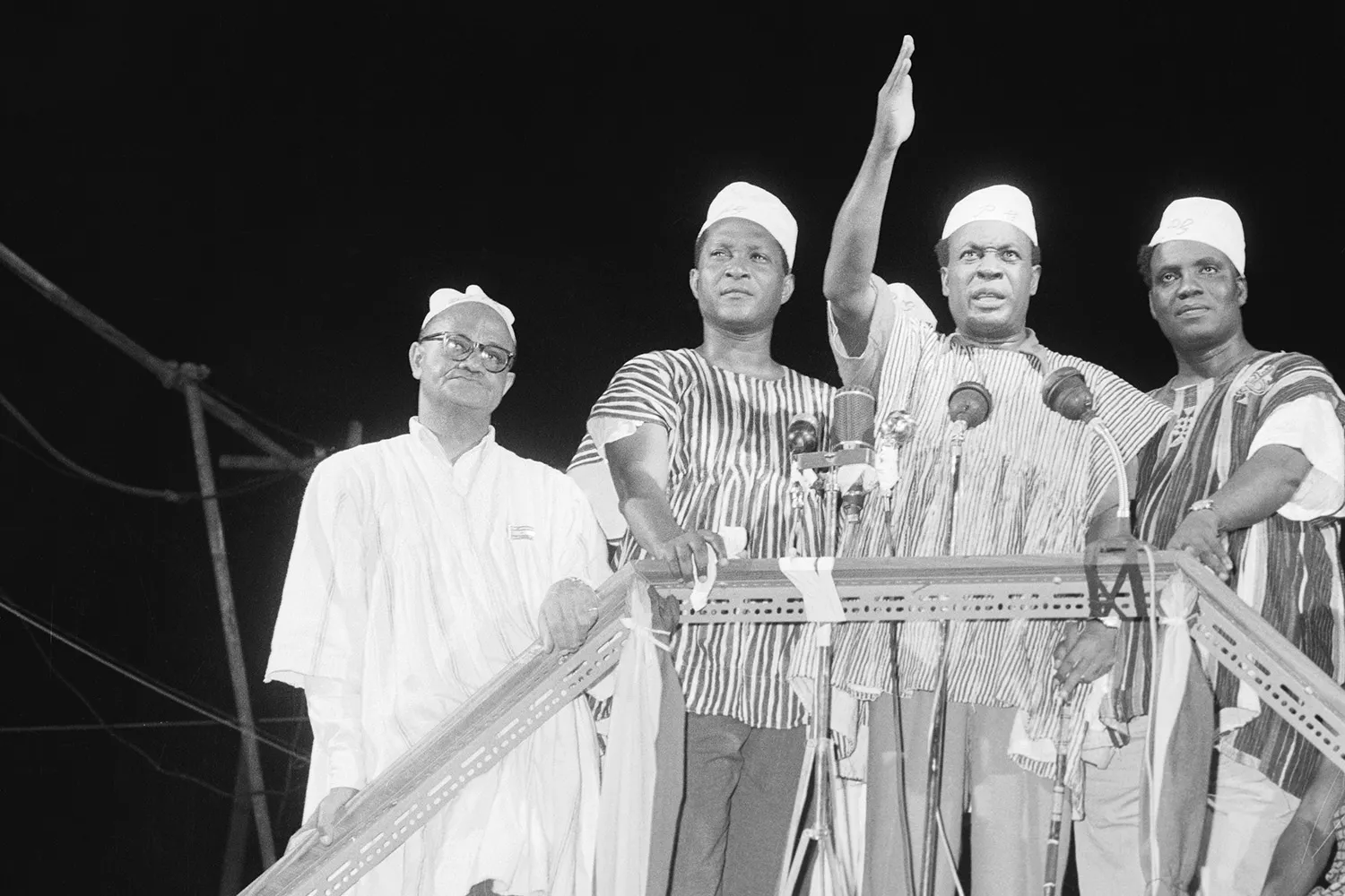 Prime Minister Kwame Nkrumah (center) waves to a celebrating crowd in Accra.