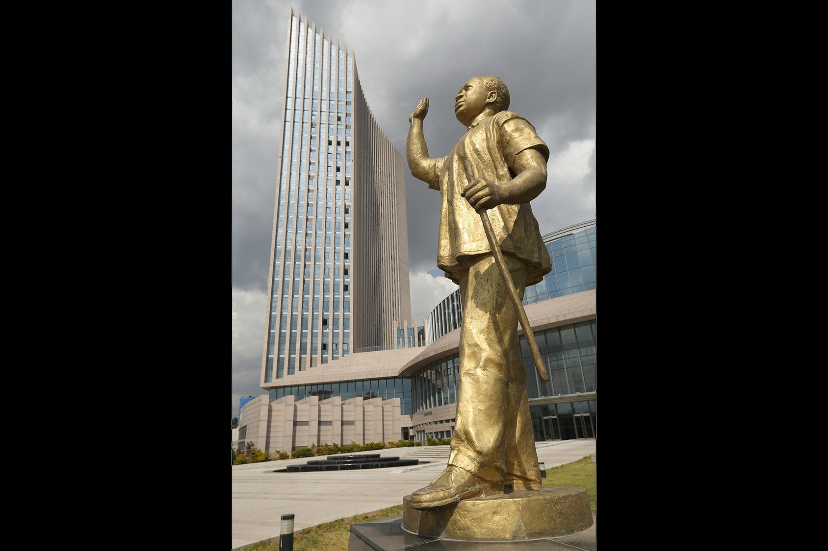 A golden statue of Kwame Nkrumah, seen with his hand raised and holding a staff, stands outside the multi-storied headquarters of the African Union in Addis Ababa, Ethiopia.