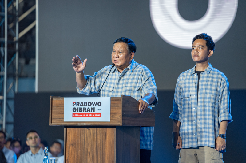 Indonesian presidential candidate Prabowo Subianto (left), alongside vice presidential candidate Gibran Rakabuming Raka, speaks to supporters at an event in Jakarta on Feb. 14.