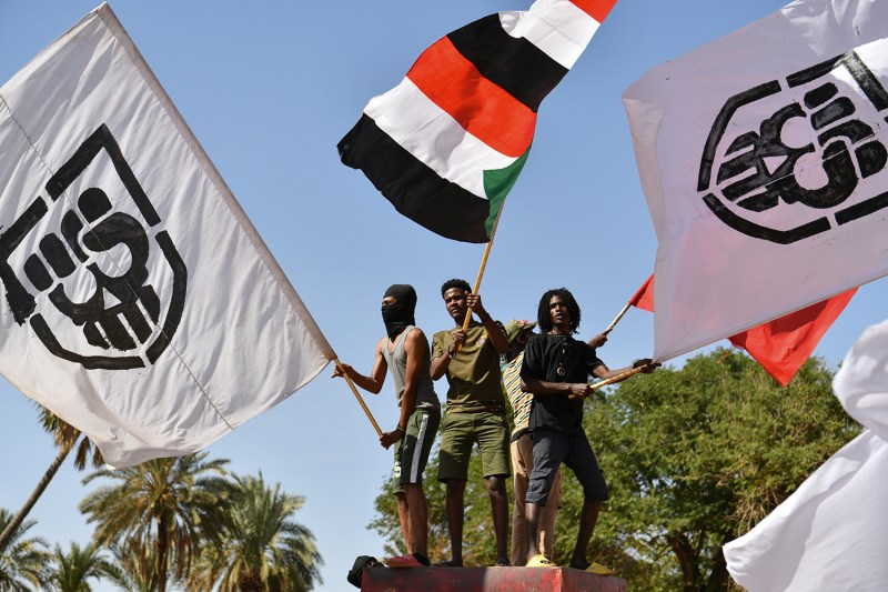 Demonstrators wave Sudanese national flags and flags representing the anti-coup youth group Angry Without Borders during a procession marking the fourth anniversary of the Sudanese revolution, in Khartoum, Sudan.