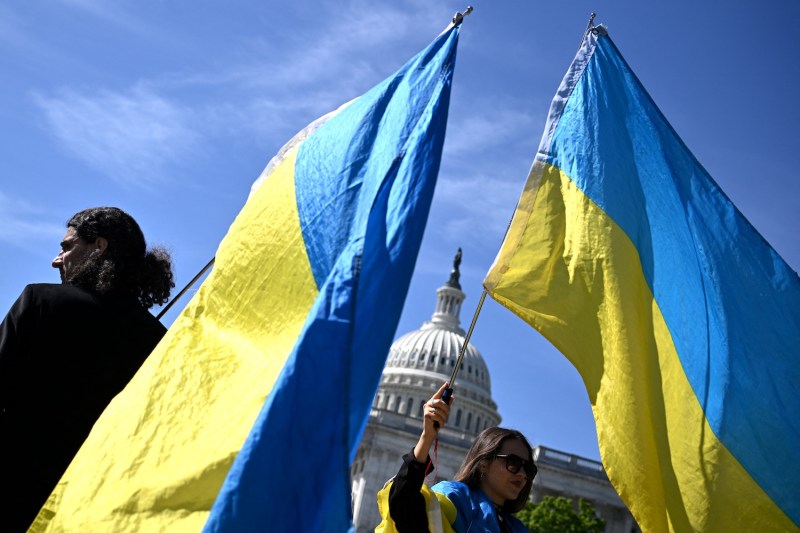 Activists wave Ukrainian flags ahead of a pivotal vote to approve new national security funding, including Ukraine aid, outside the U.S. Capitol in Washington, D.C.