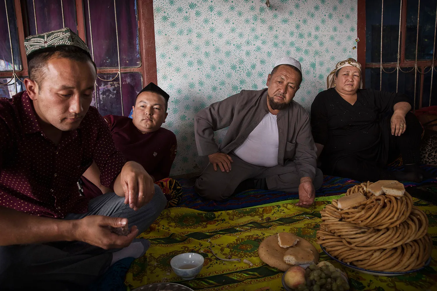 A Uyghur family gathers for a meal during the Corban Festival in Xinjiang province, China.