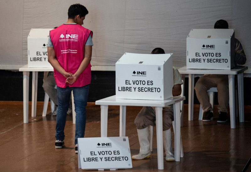 An employee of Mexcio's National Electoral Institute oversees early voting for Mexico's general election.