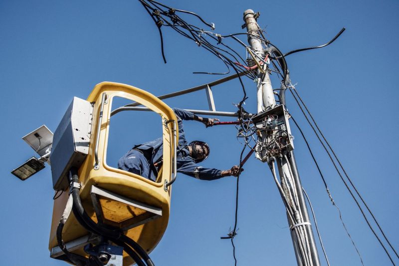 A city power worker removes an illegally connected electrical cable in  Johannesburg, South Africa, on June 9, 2022.