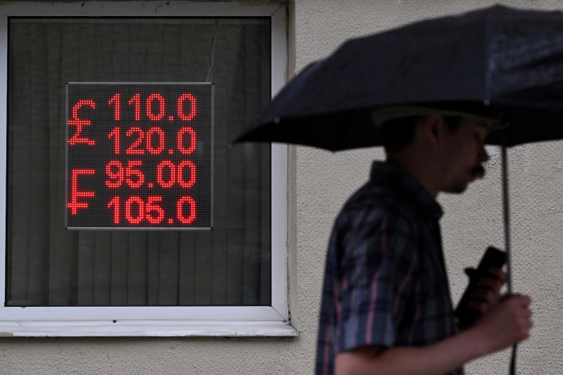 A man walks past a currency exchange office in Moscow.