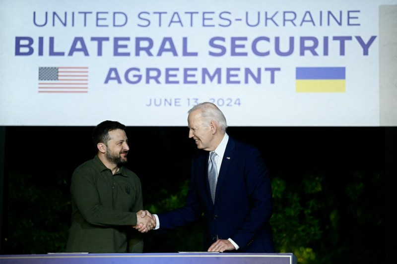 Ukrainian President Volodymyr Zelensky (left) and U.S. President Joe Biden shake hands after signing a bilateral security agreement on the sidelines of the G-7 summit in Italy's Apulia region on June 13.