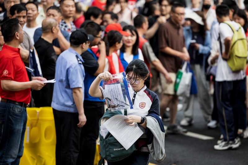 A student enters a school on the first day of the national college entrance exam, known as "gaokao," in Wuhan, China.