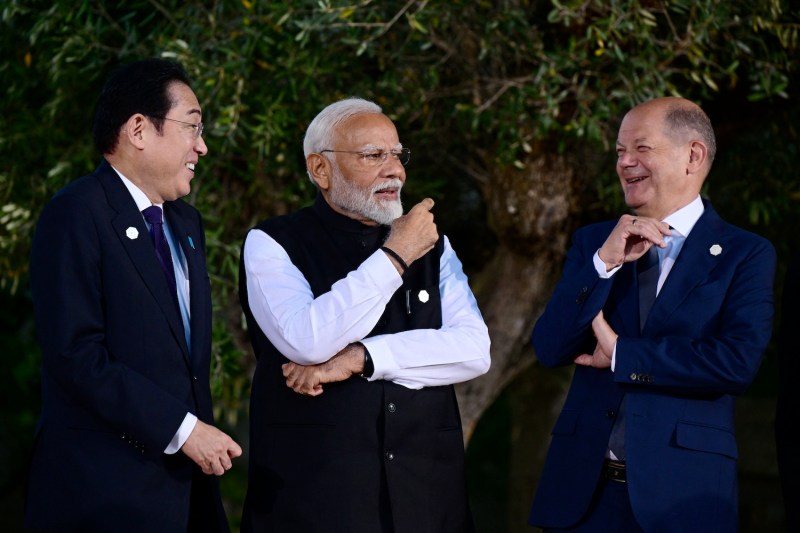 Japanese Prime Minister Fumio Kishida, Indian Prime Minister Narendra Modi, and German Chancellor Olaf Scholz joke before a group photo during the G-7 summit in Savelletri, Italy, on June 14.