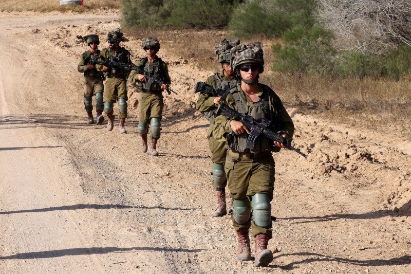 Israeli army soldiers patrol around a position along Israel's southern border with the Gaza Strip on June 13.