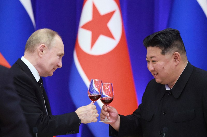 Russian President Vladimir Putin and North Korean leader Kim Jong Un toast during a state visit in Pyongyang on June 19, in a photo distributed by the Russian state agency Sputnik.