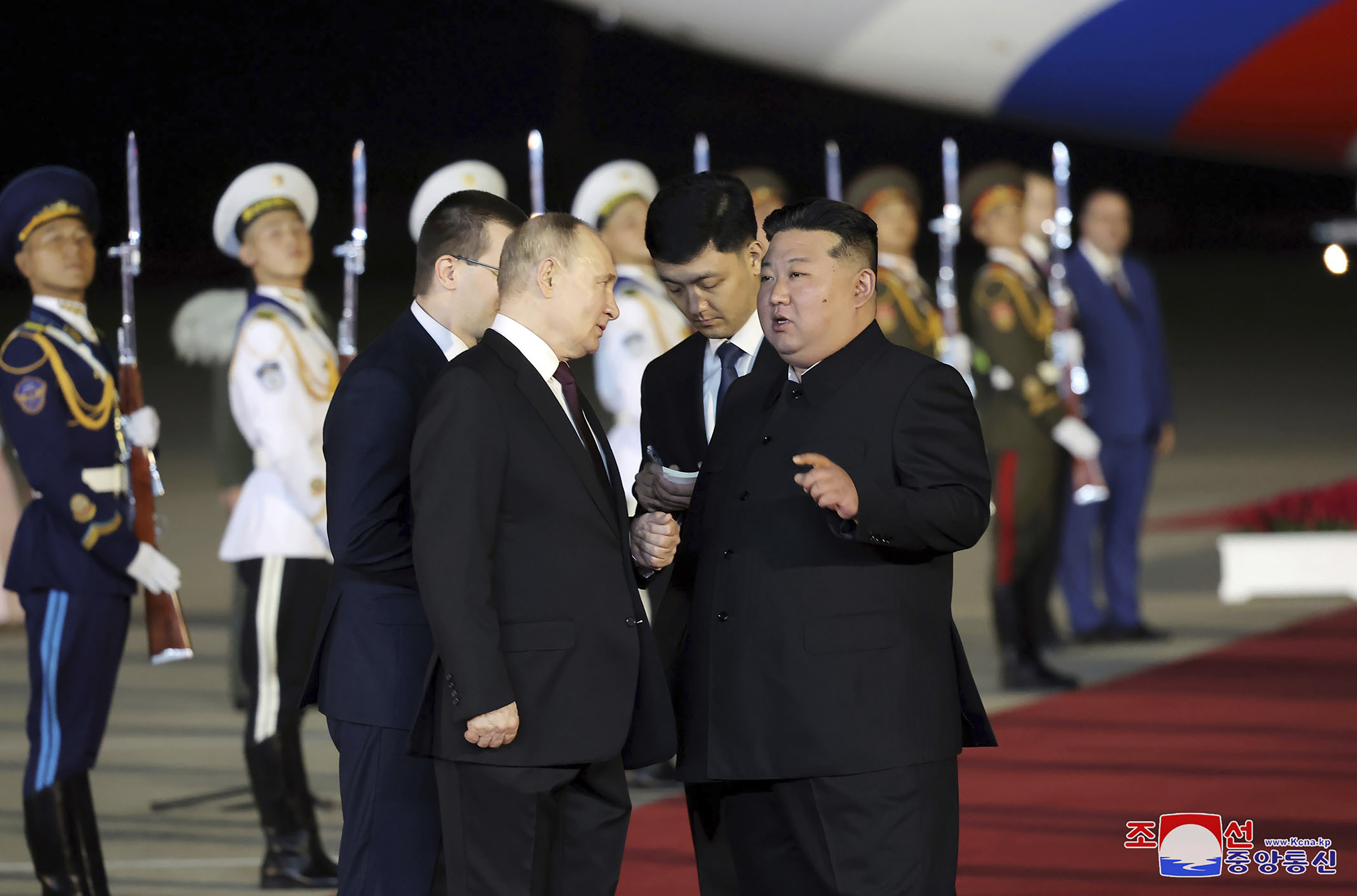 In this photo provided Wednesday, June 19, 2024, by the North Korean government, Russian President Vladimir Putin, center left, and North Korea's leader Kim Jong Un, center right, talk upon Putin's arrival at the Pyongyang International Airport in Pyongyang, North Korea, early Wednesday, June 19. The content of this image is as provided and cannot be independently verified. Korean language watermark on image as provided by source reads: "KCNA" which is the abbreviation for Korean Central News Agency. (Korean Central News Agency/Korea News Service via AP)