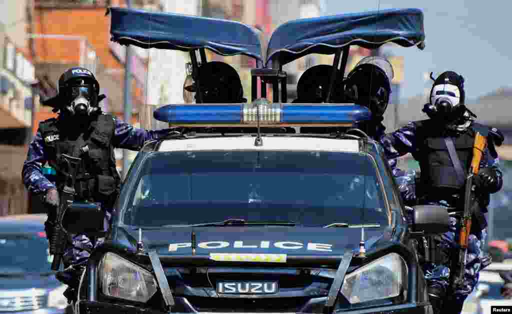 Riot police officers patrol the streets during a rally against what the protesters say are rampant corruption and human rights abuses by the country&#39;s rulers in Kampala, Uganda. REUTERS/Michael Muhati