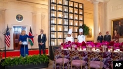 First lady Jill Biden, next to White House Social Secretary Carlos Elizondo, gestures toward the table setting, May 22, 2024, ahead of Thursday evening's State Dinner with Kenya's President William Ruto, at the White House.