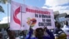 Members of the United Methodist Church in Zimbabwe hold placards while holding a protest at the church premises in Harare, Thursday, May 30, 2024.