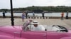 A driver parks a vintage car as Russian nuclear-powered cruise missile submarine Kazan enters Havana’s bay, Cuba, June 12, 2024. 