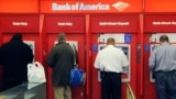 FILE - Customers use ATMs at a Bank of America branch office in Boston, Oct. 16, 2009. (AP Photo/Lisa Poole, File)