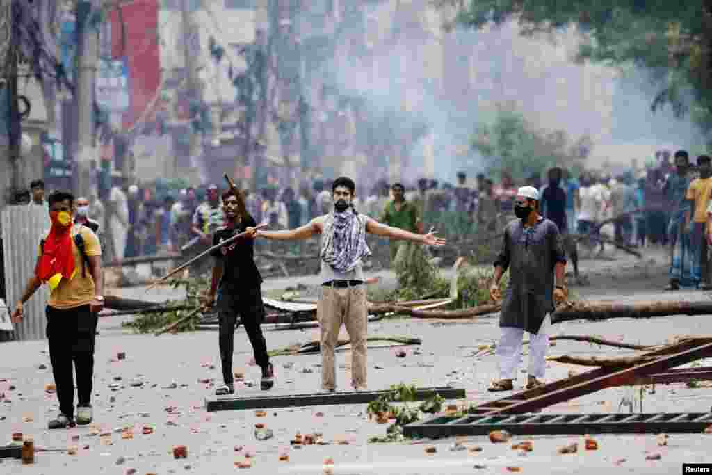 A demonstrator is seen as protesters clash with Border Guard Bangladesh (BGB) and the police outside the state-owned Bangladesh Television as violence erupts across the country after anti-quota protests by students, in Dhaka, Bangladesh.