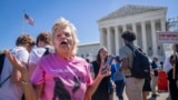 Celeste McCall, of Washington, reacts in confusion, July 1, 2024, outside the Supreme Court in Washington after decisions were announced.