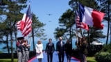 U.S President Joe Biden, first lady Jill Biden, French President Emmanuel Macron and his wife Brigitte Macron attend the 80th anniversary of D-Day at the Normandy American Cemetery and Memorial in Colleville-sur-Mer, France, June 6, 2024. 