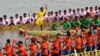 Participants row dragon boats during a competition as part of the Water Festival on the Tonle Sap river in Phnom Penh on November 26, 2023.