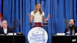 Lara Trump, the newly elected co-chair of the Republican National Committee, speaks as Chairman Michael Whatley, left, and outgoing Co-Chair Drew McKissick listen at the organization's meeting in Houston, Texas, March 8, 2024.