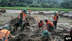 Rescue officials sift through debris at the site of a landslide in the remote mountainous village of Lang Nu, in Lao Cai province on Sept. 12, 2024, in the aftermath of Typhoon Yagi hitting northern Vietnam.