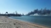 (FILE) Smoke rises after shelling near a seaport in Berdyansk, Ukraine, Thursday, March 24, 2022.