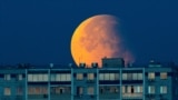 A partial lunar eclipse is seen over the residential building in Moscow, Russia, Sept. 18, 2024.